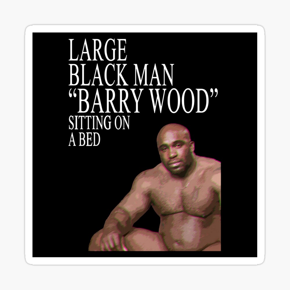 Large Black Man Barry Wood Sitting On a Bed