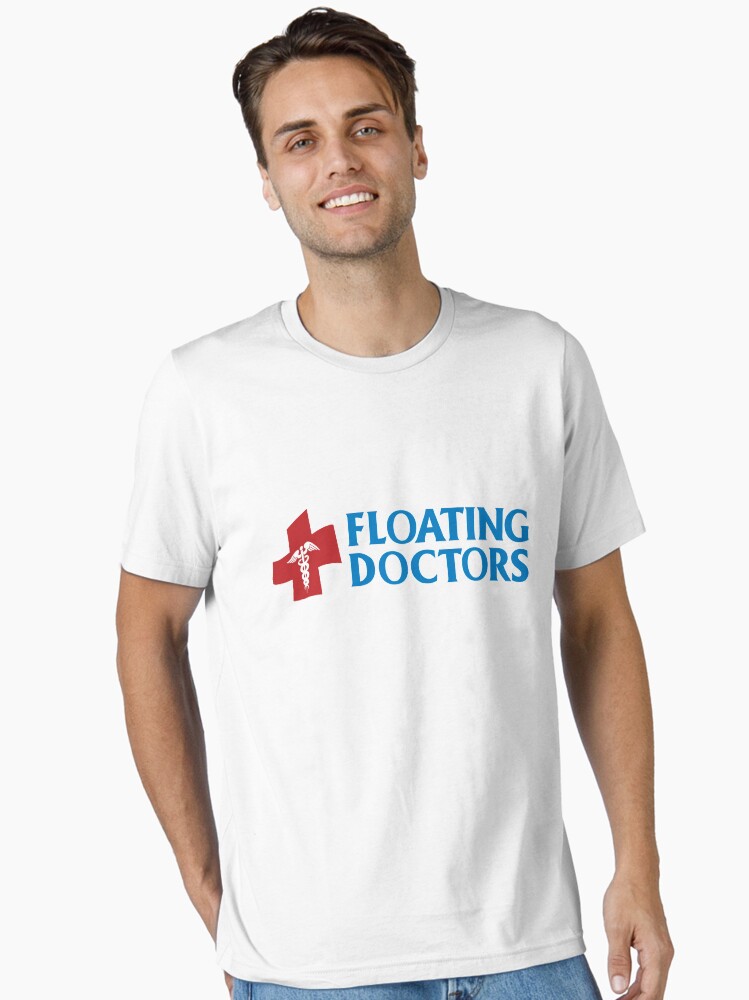 Imagen 1 de 7, Camiseta esencial con la obra Logotipo de cruz médica de médicos flotantes, diseñada y vendida por FloatingDoctors.