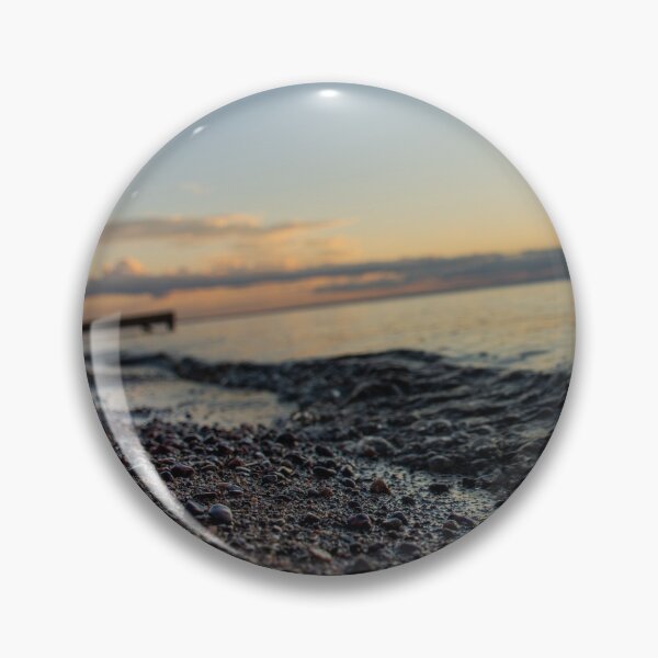 Item preview, Sunrise over clouds on lake and closeup on water wave and sand rocks designed and sold by olivierbradette.