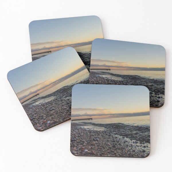 Item preview, Sunrise over clouds on lake and closeup on water wave and sand rocks designed and sold by olivierbradette.