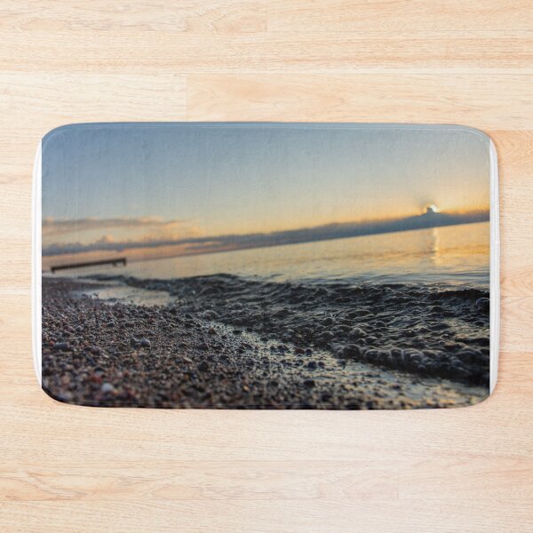 Item preview, Sunrise over clouds on lake and closeup on water wave and sand rocks designed and sold by olivierbradette.
