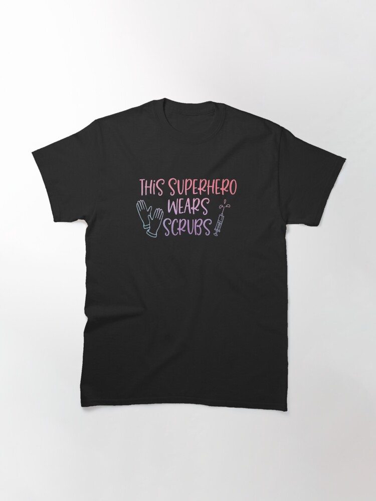 Thumbnail 3 of 7, Classic T-Shirt, This Superhero Wears Scrubs designed and sold by Dollfacedesign.