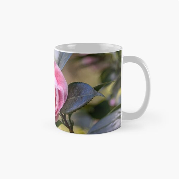 Item preview, Pink camellia flower, with branches and leaves in the background. designed and sold by AylaHarbich.