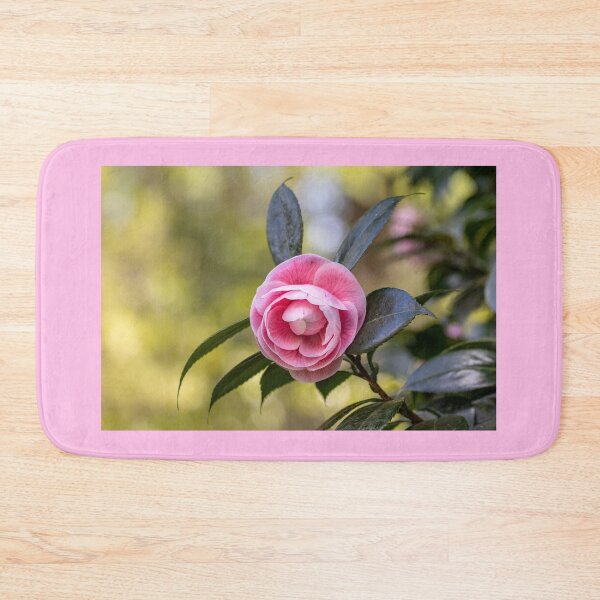 Item preview, Pink camellia flower, with branches and leaves in the background. designed and sold by AylaHarbich.