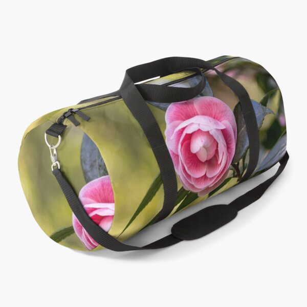 Item preview, Pink camellia flower, with branches and leaves in the background. designed and sold by AylaHarbich.
