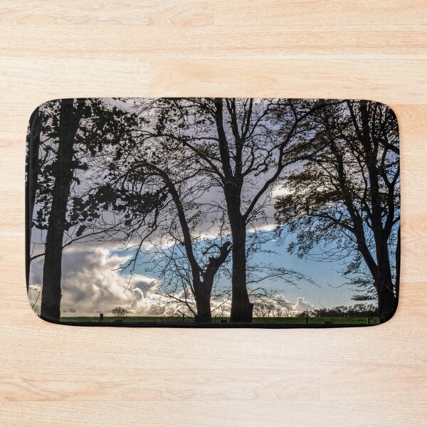 Item preview, Silhouetted trees on a blue sky and white clouds background designed and sold by StencilMyst ..