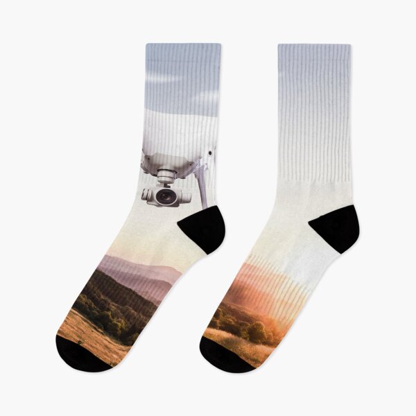 Item preview, Close up of hovering drone taking pictures of green meadows and hills at sunset designed and sold by TravelDrone.