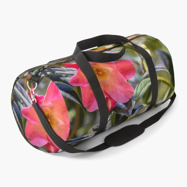 Item preview, Pink camellia flower, with branches and leaves in the background. designed and sold by AylaHarbich.