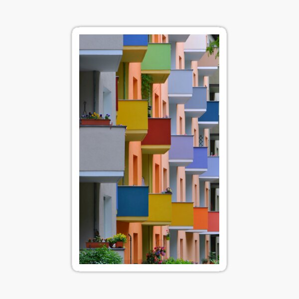 Farben, Berlin, Germany, 2015 by Mokusho Abigaëlle Richard, is a color photo of multi colored buildings and balconies with flowers. Sticker