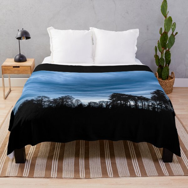 Item preview, A dramatic blue stormy sky with clouds at sunset over a forest in Ireland designed and sold by AlbertMi.