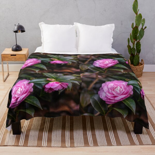 Item preview, Pink camellia flower, with branches and leaves in the background. designed and sold by AylaHarbich.