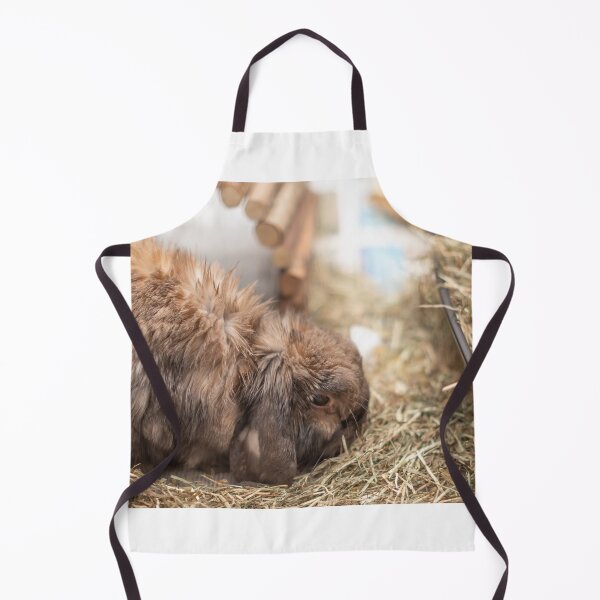 Item preview, Cute lop eared bunny rabbit eating hay in its cage designed and sold by yackers1.