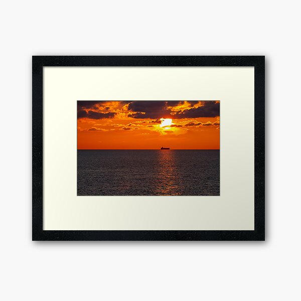Cargo ship in the sunset Framed Art Print