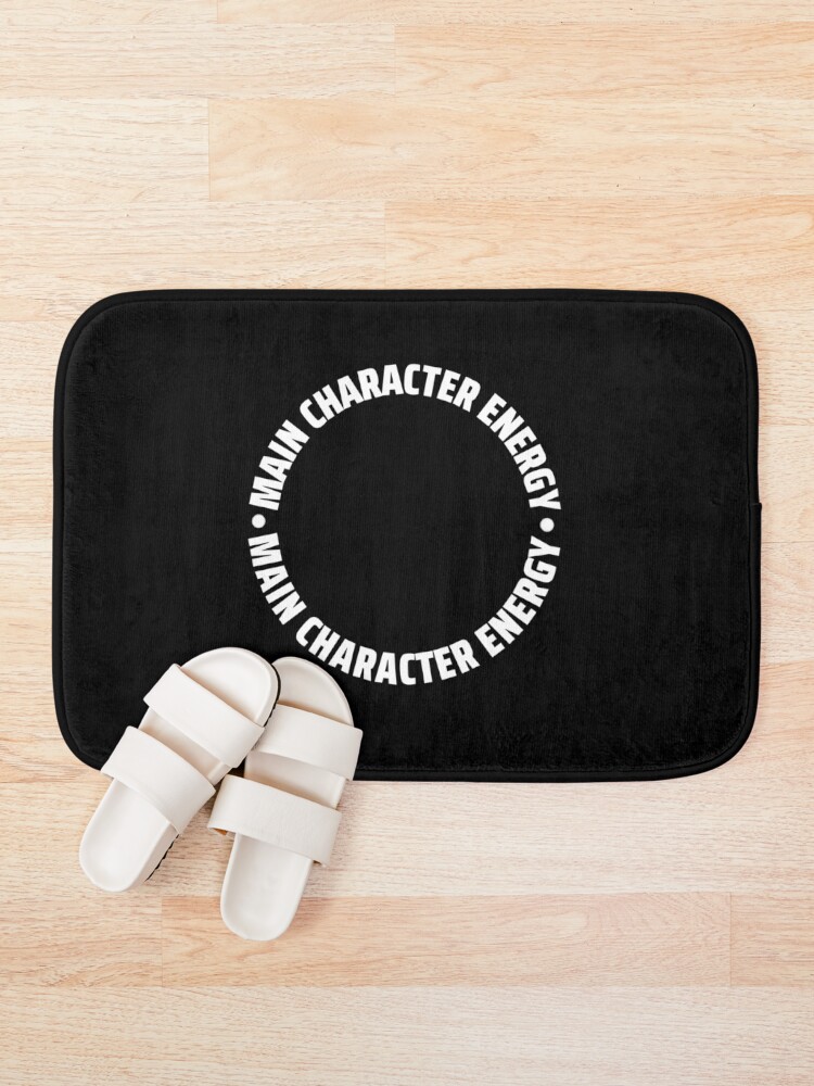 Thumbnail 1 of 6, Bath Mat, Main Character Energy Circular Frame Design | Small Left Pocket White Text designed and sold by R-reflections.