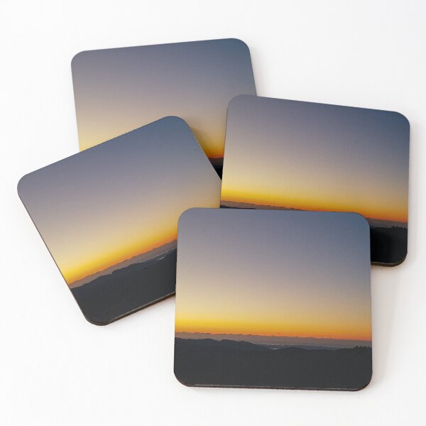 As the sun descends below the horizon, the sky is transformed into a canvas of breathtaking hues. Shades of pink, orange, and gold paint the sky, casting a warm and magical glow Coasters (Set of 4)