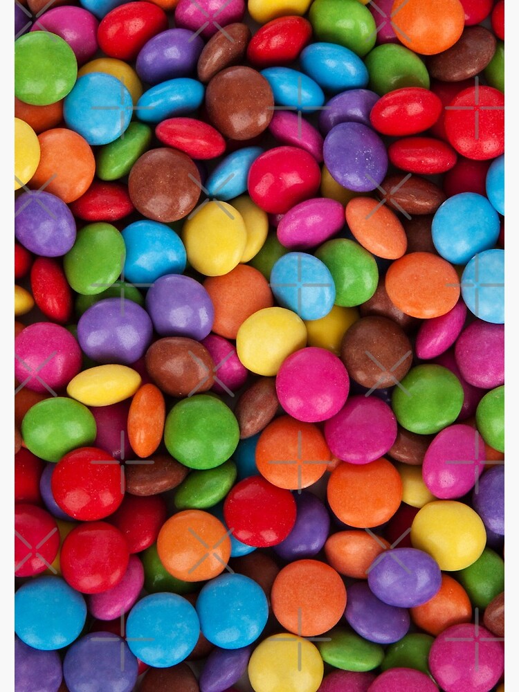 M&M's candy on the red background, colorful candy and multicolored