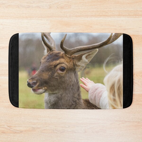Item preview, Blonde girl playing with a friendly deer in Phoenix Park, Dublin, Ireland designed and sold by AlbertMi.