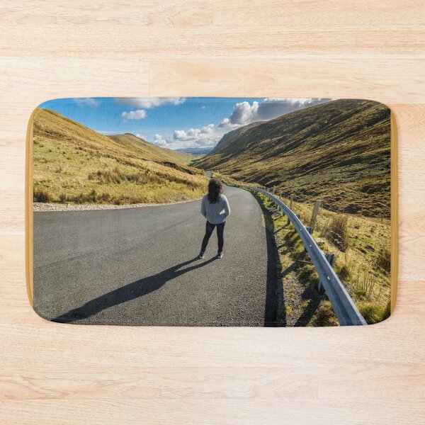 Item preview, A young beautiful woman with long curly hair stands on the highway of the Glengesh Pass between the mountains in Ardara, County Donegal, Ireland designed and sold by AlbertMi.
