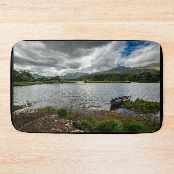 Item preview, A boat on a lake by a mountains under a cloudy sky in Killarney National Park, near the town of Killarney, County Kerry, Ireland designed and sold by AlbertMi.