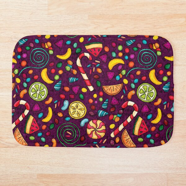 Bonbons multicolores sur fond violet Tapis de bain