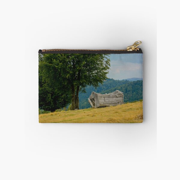Item preview, Abandoned disintegrating shepherd's hut and a tree in a mountain pasture in Transylvania designed and sold by BZsArt.