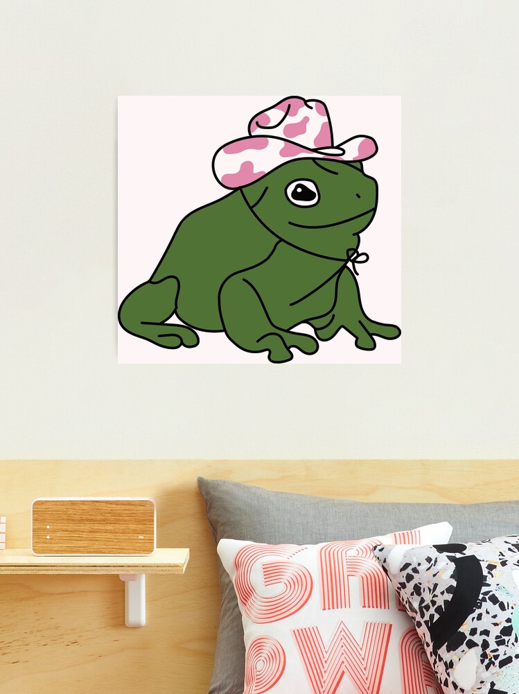 Cowboy Frog Keychain  Philly FrogsThis round clear acrylic keychain  features a dumpy tree frog with a cowboy hat. The text around the frog  states, “Moisturized. Happy. In my lane. Focused. Flourishing.