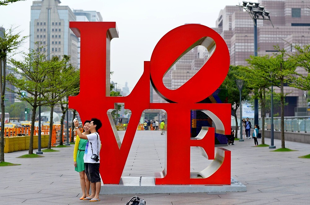 "Couple at the LOVE sign in Taipei, Taiwan" by morariu Redbubble