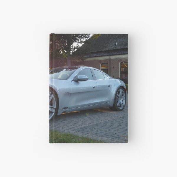 2012 Fisker Karma electric supercar against a sunset Hardcover Journal