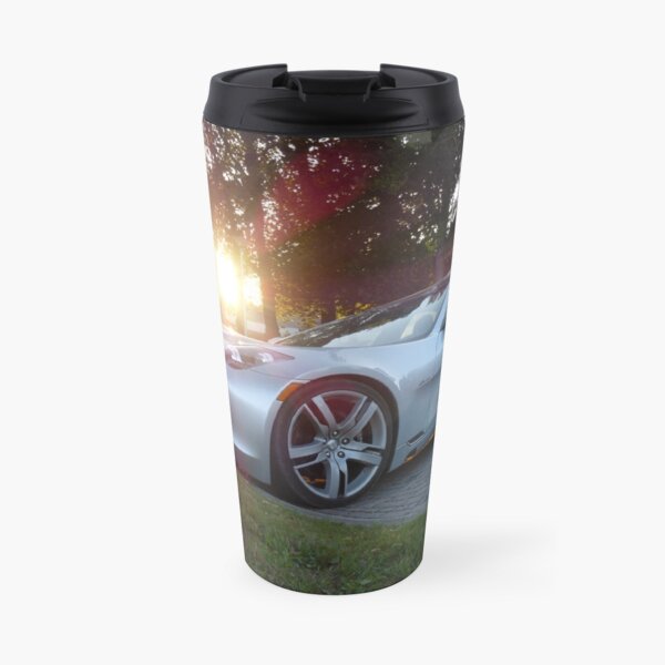 2012 Fisker Karma electric supercar against a sunset Travel Mug