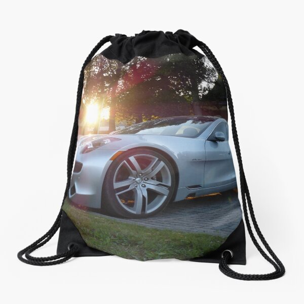 2012 Fisker Karma electric supercar against a sunset Drawstring Bag