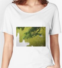 Tree branch leaning over a green lake. Women's Relaxed Fit T-Shirt