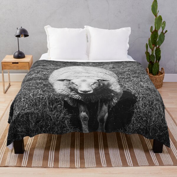 Item preview, A close up portrait photograph of a cute, curious farm sheep in a grass landscape in black and white designed and sold by Diana van Neck.