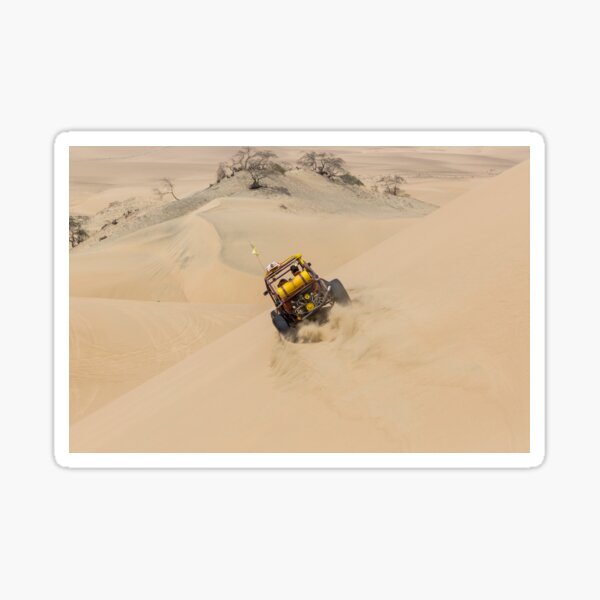 Dune buggy with passengers speeding across the side of a large dune Sticker