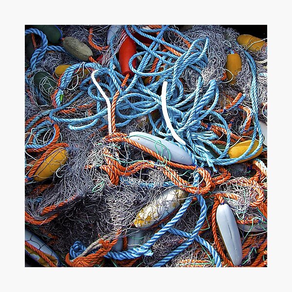 Framed Print of Ropes, fishing nets and floats on the quay in