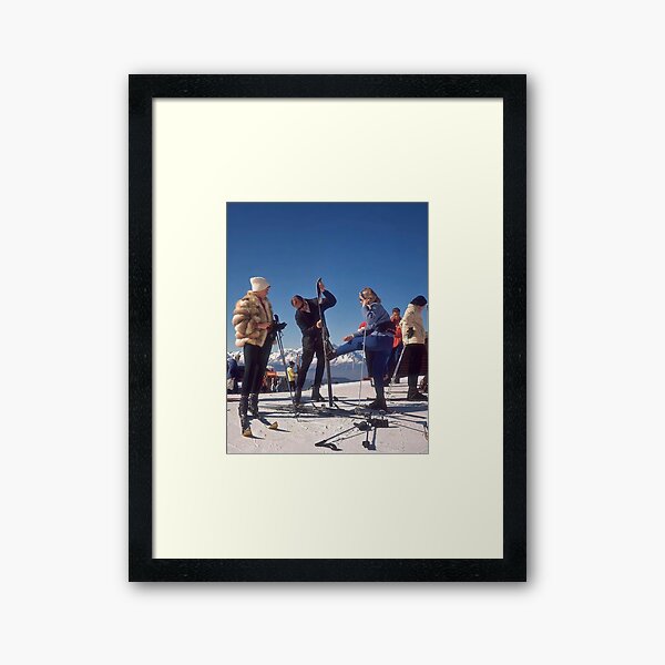 A Gentleman Helping A Lady Get Her Ski On In Verbier Switzerland 1964 Framed Art Print