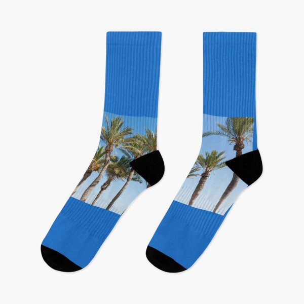 Item preview, Row of tropical feeling palm trees against blue sky with luch green fronds. designed and sold by Brian Scantlebury.