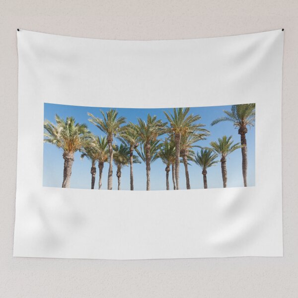 Item preview, Row of tropical feeling palm trees against blue sky with luch green fronds. designed and sold by Brian Scantlebury.