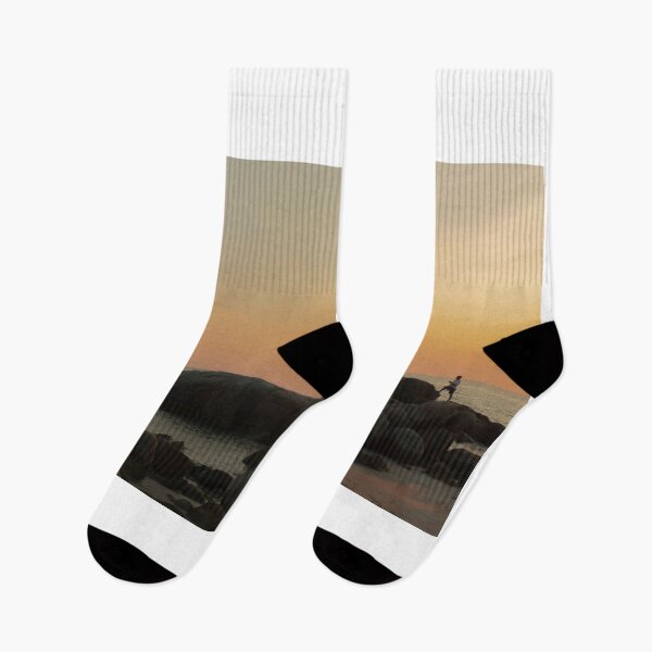 Item preview, The stones on beach in evening have the background of the sea and the evening sun. There are people standing on rocks and flags designed and sold by WP-7824.