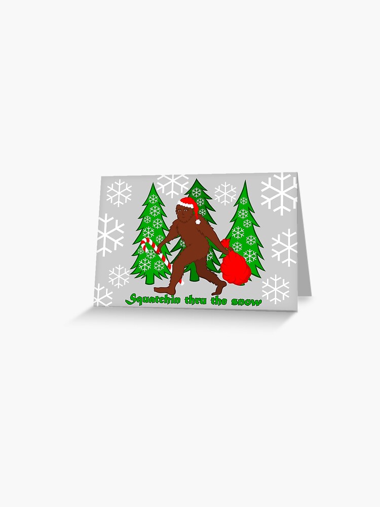 Thumbnail 1 of 2, Greeting Card, Squatchin Thru The Snow Funny Christmas Bigfoot designed and sold by theartofvikki.