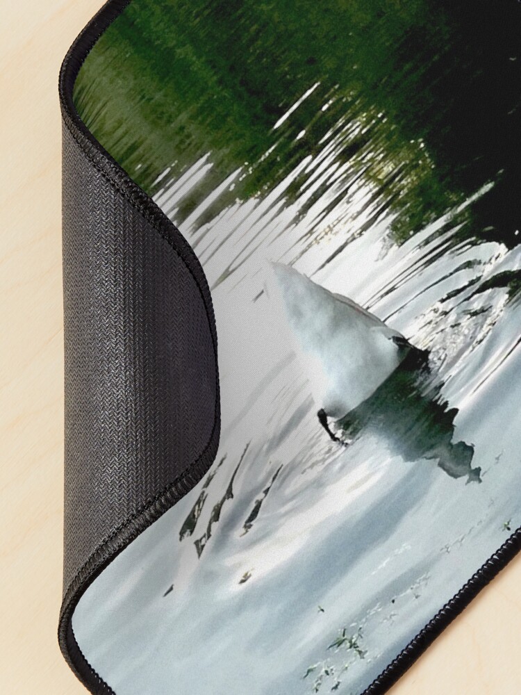Alternate view of Duck with its head in the water and its white tail up on a lake with water with green reflections from the willows on the edge and blue from the sky Mouse Pad