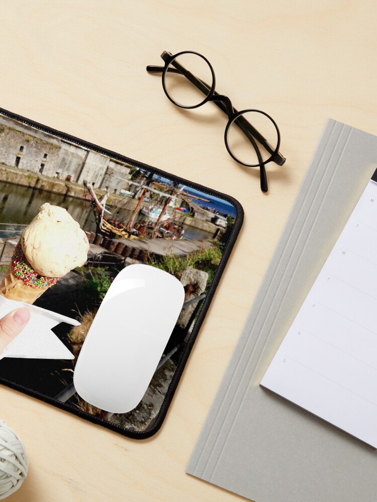 Alternate view of Person holding an ice cream cone near a sailboat and an old building, sunny day with clouds in the sky Mouse Pad