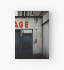Old abandoned garage with red sign in historical center of Strasbourg Hardcover Journal