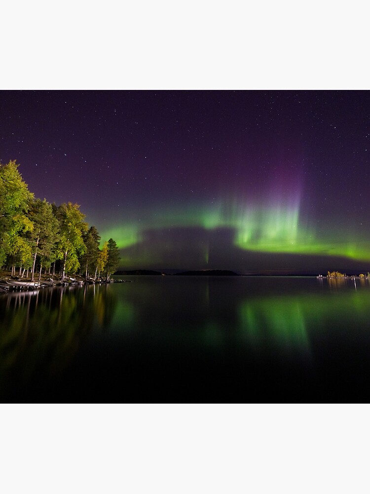 Northern lights glowing over lake in Finland by Juhku