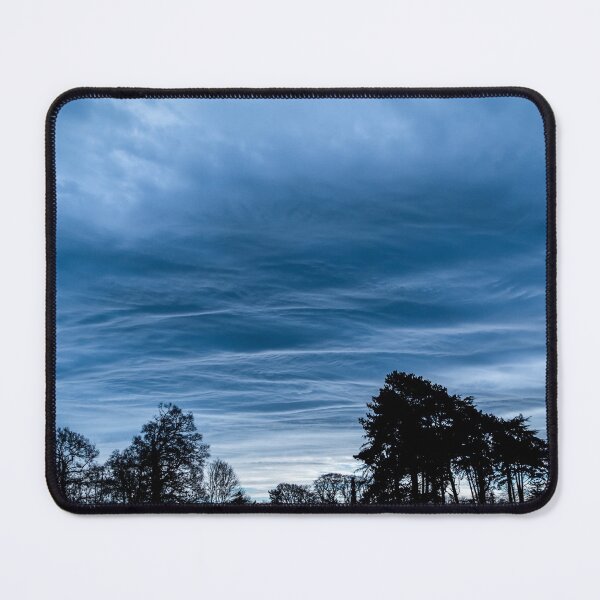 Item preview, A dramatic blue stormy sky with clouds at sunset over a forest in Ireland designed and sold by AlbertMi.