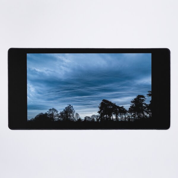 Item preview, A dramatic blue stormy sky with clouds at sunset over a forest in Ireland designed and sold by AlbertMi.