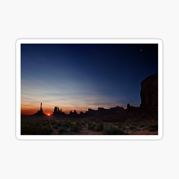 Moon watches sun rise at Totem Pole Sticker