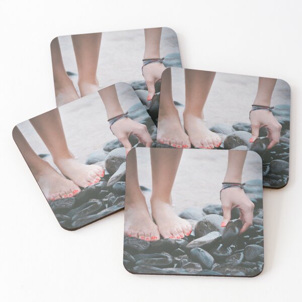 Item preview, A low shot of a woman standing on wet pebbles and picking up one of them.  designed and sold by FindYouByZ.