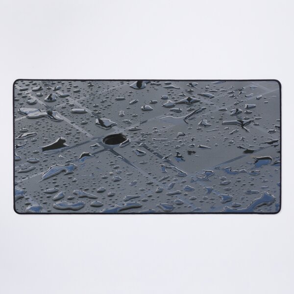 Globules of rain sit up on top of plastic table Desk Mat