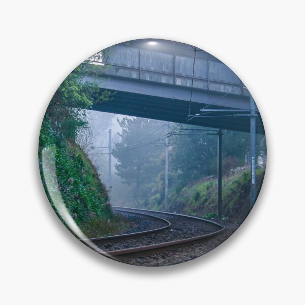 Item preview, Lonely train tracks disappearing under a bridge and into a foggy morning landscape designed and sold by James-Cole.