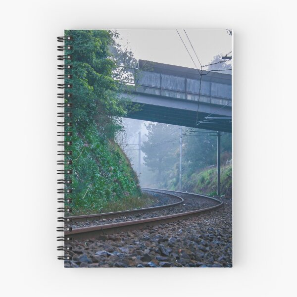 Item preview, Lonely train tracks disappearing under a bridge and into a foggy morning landscape designed and sold by James-Cole.